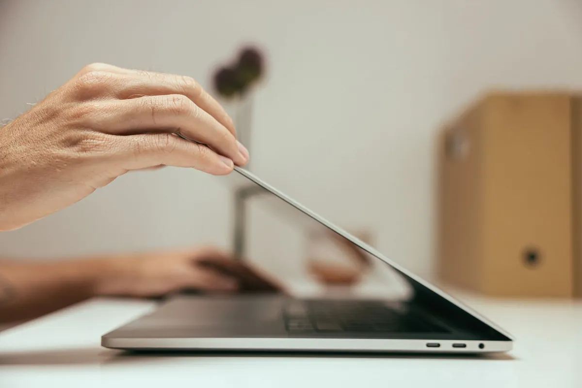 person setting boundaries laptop closed end of work day