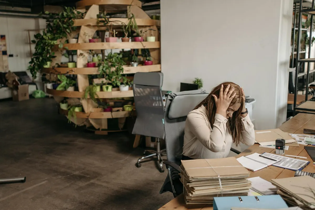 stressed professional at desk overwhelmed UK office
