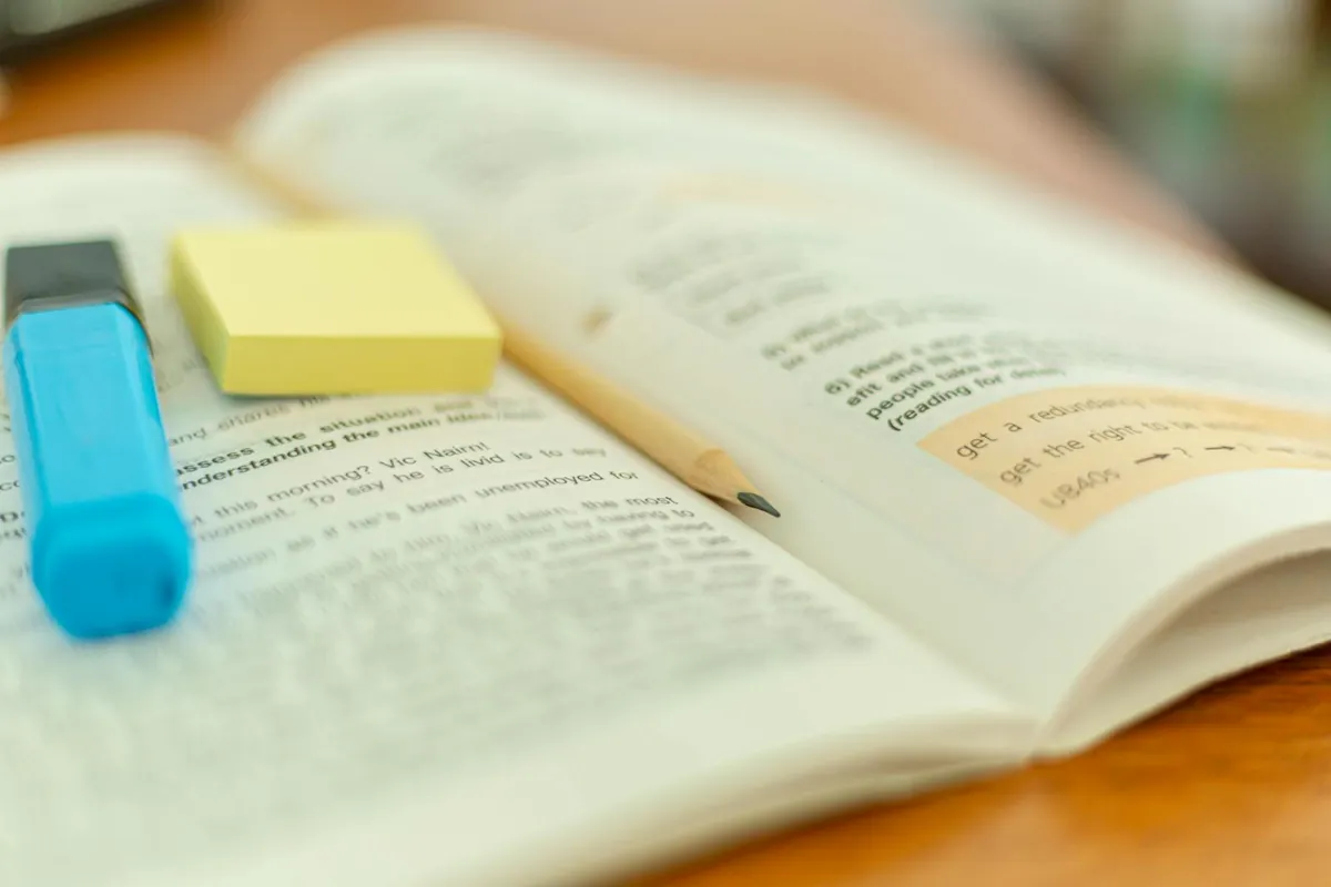 open book with highlighted notes and pen