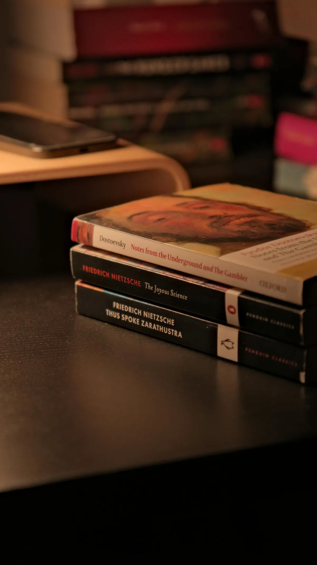 stack of leadership books on desk reading