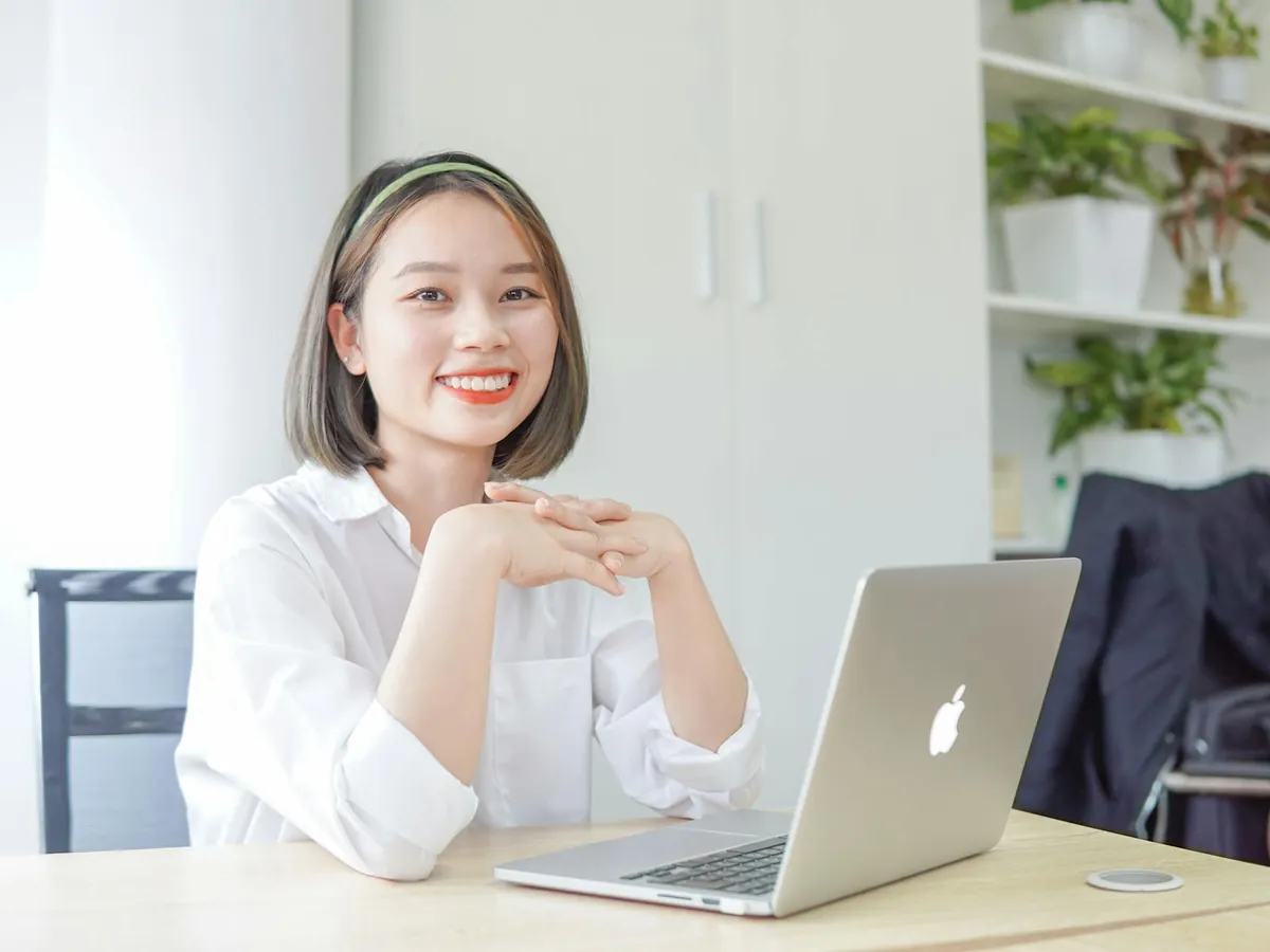 woman confident new job desk laptop notebook setup
