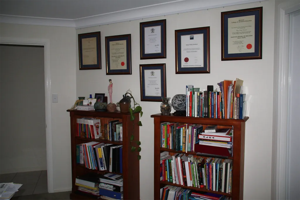 certificate hanging on wall with laptop